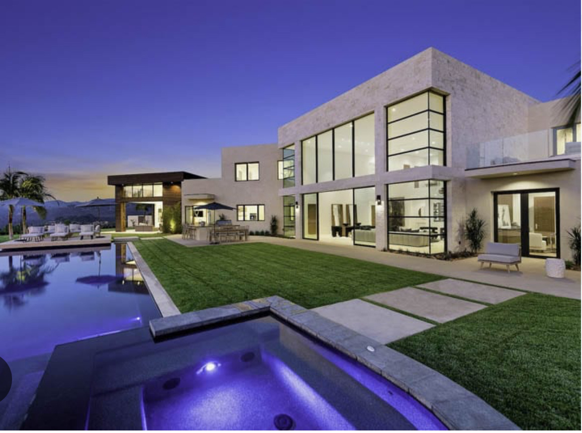 a beautiful home with a pool that just got a hose wash